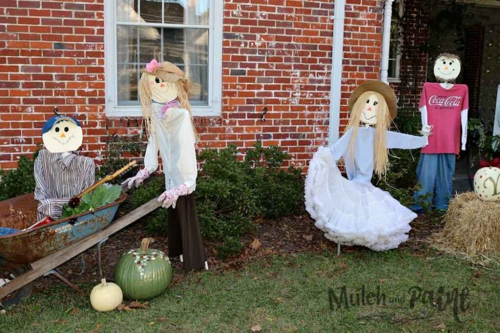 Creative DIY family scarecrows dressed in personalized outfits and arranged outdoors for fall.